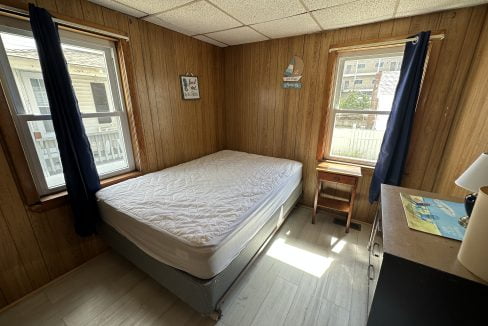 a bedroom with a bed and a desk in it.