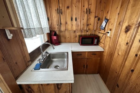 a kitchen with wood paneling and a sink.