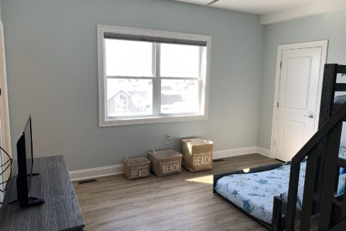 a bedroom with a bed and a tv in it.