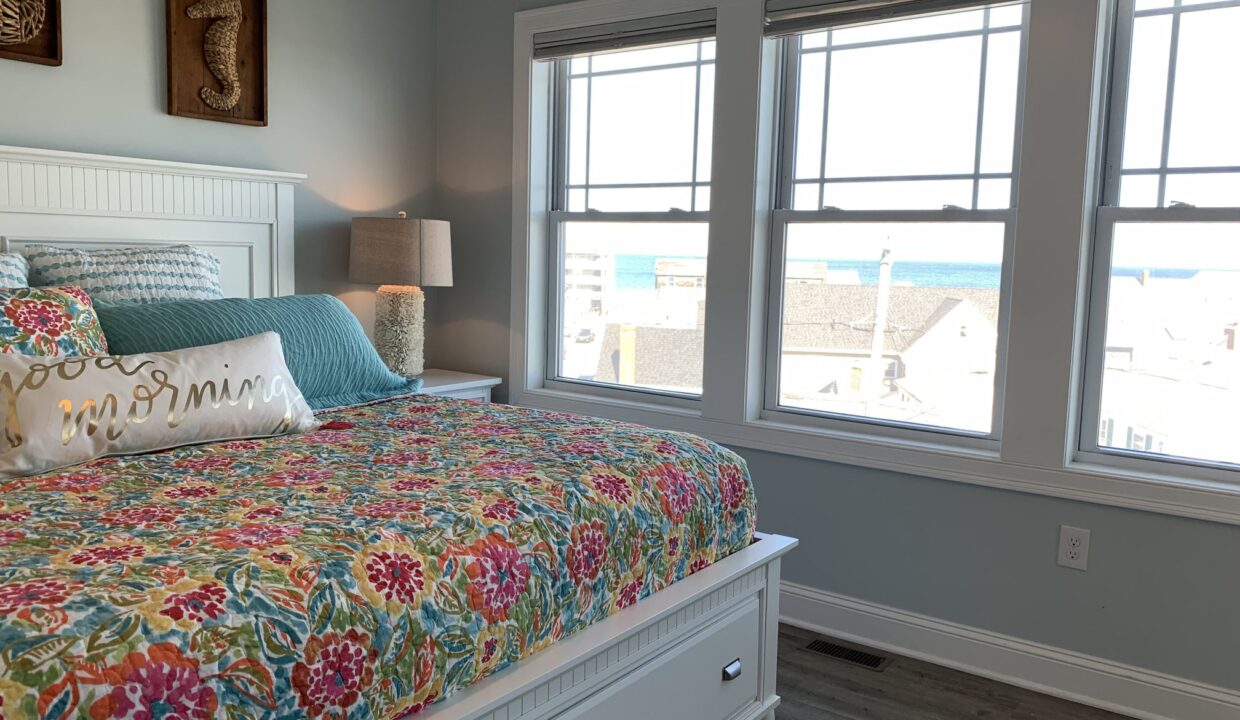 a bedroom with a bed and two windows.