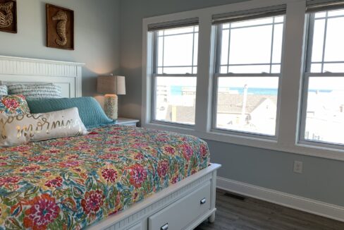 a bedroom with a bed and two windows.