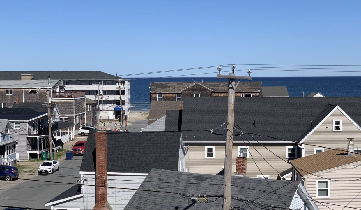 a view of the ocean from a rooftop of a house.