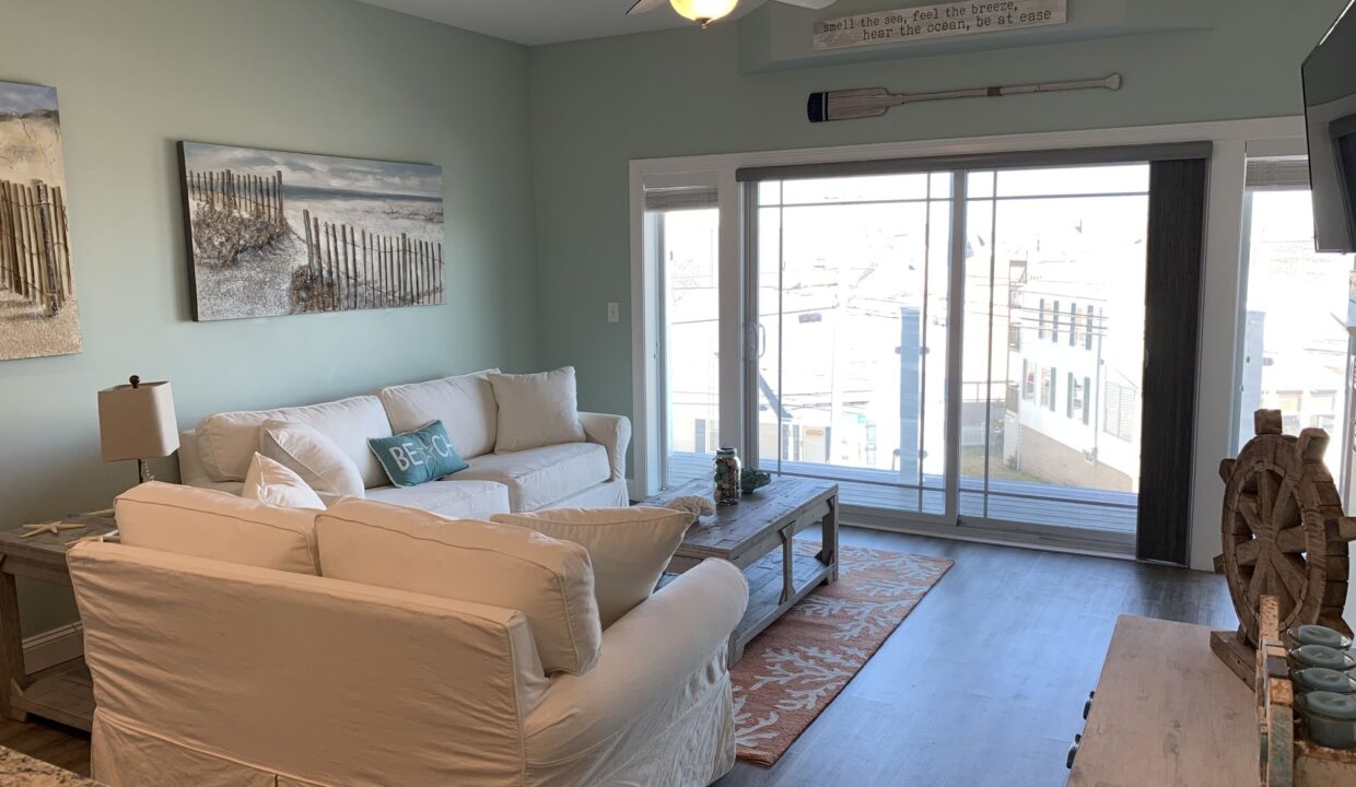 a living room filled with furniture and a flat screen tv.