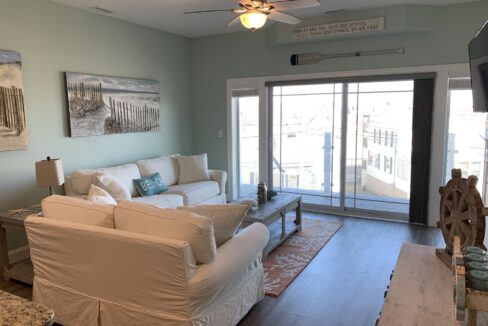 a living room filled with furniture and a flat screen tv.