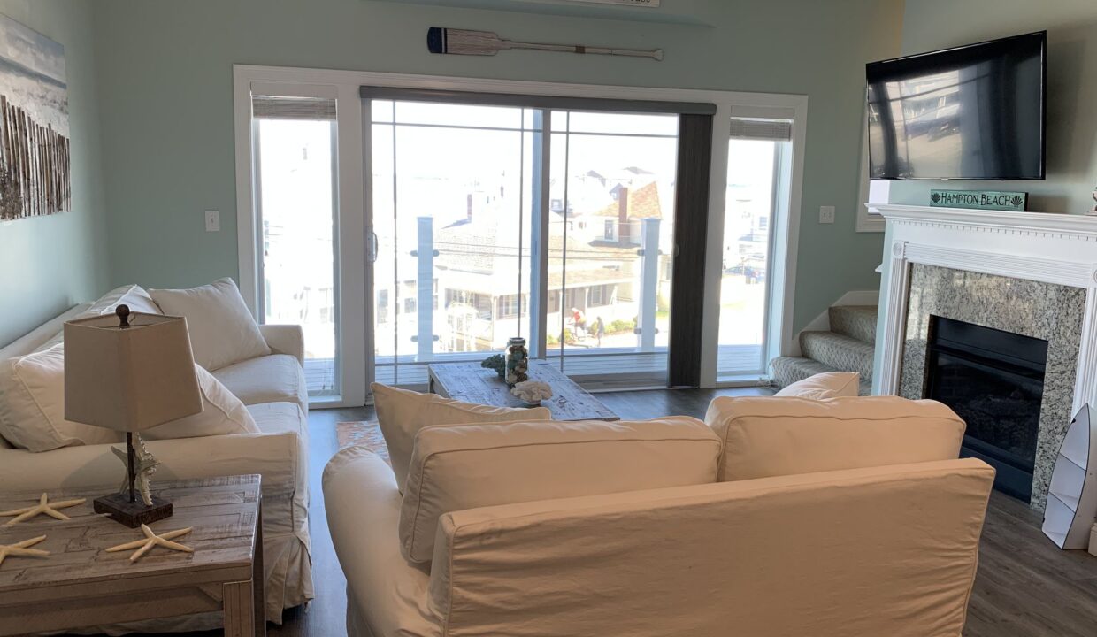 a living room filled with furniture and a flat screen tv.