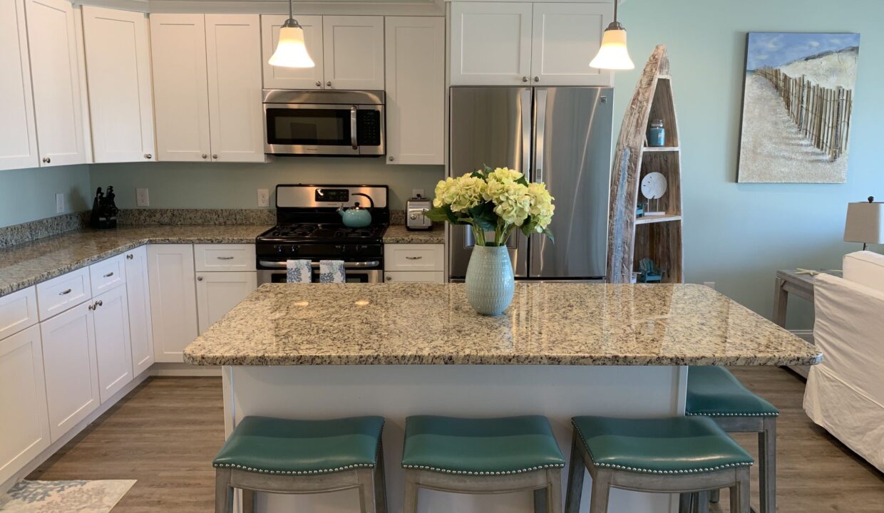 a kitchen with a center island with stools.