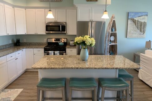 a kitchen with a center island with stools.