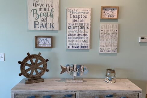 a room with a dresser and a clock on the wall.