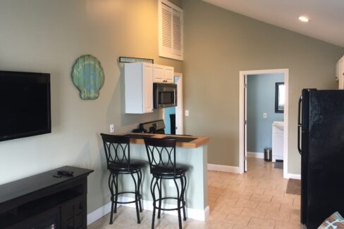 a kitchen with a black refrigerator freezer sitting next to a counter.