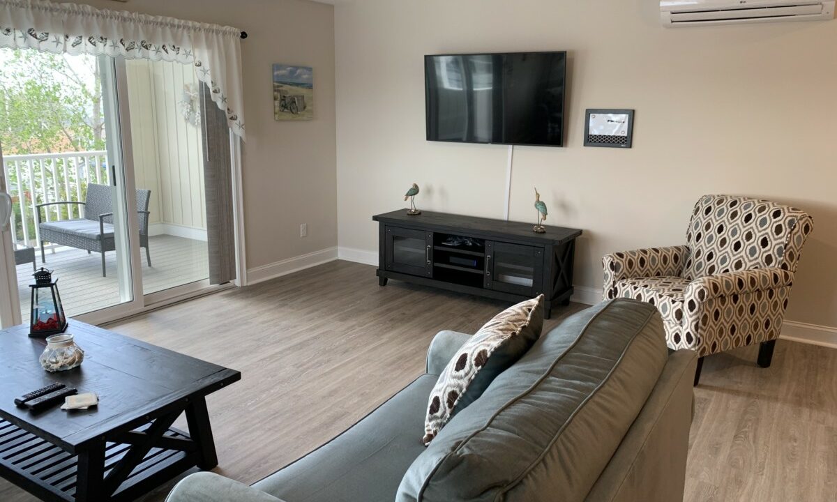 a living room filled with furniture and a flat screen tv.