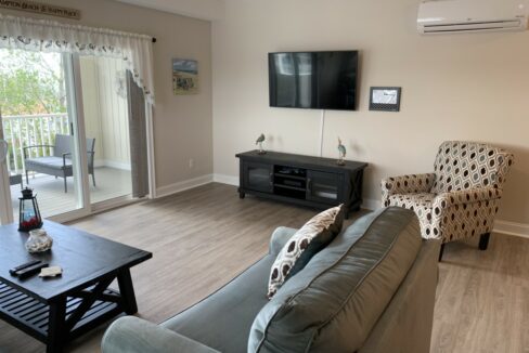 a living room filled with furniture and a flat screen tv.