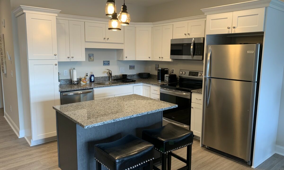 a kitchen with an island and two stools.