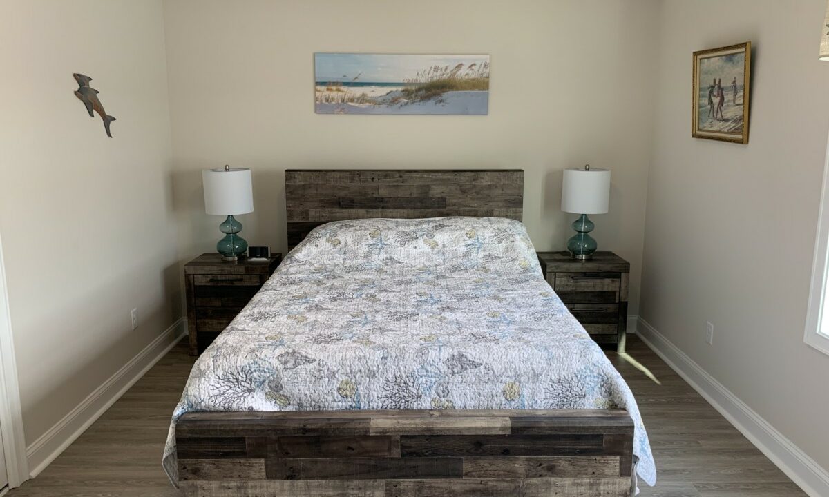 a bed sitting in a bedroom next to two night stands.