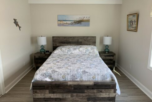 a bed sitting in a bedroom next to two night stands.