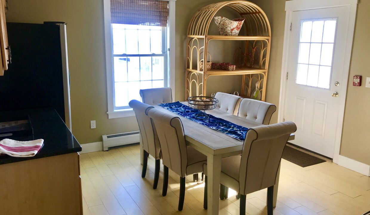 a dining room with a table and chairs.