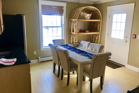 a dining room with a table and chairs.