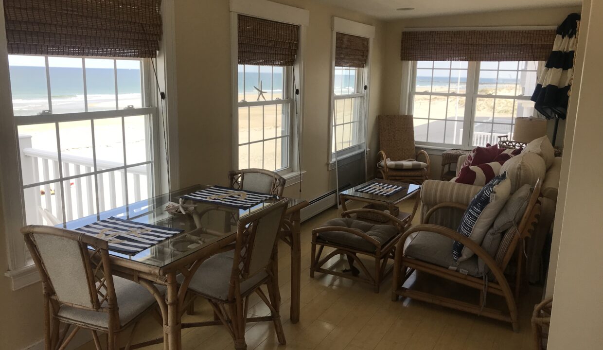 a living room filled with furniture and windows.