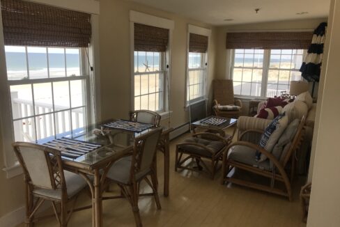 a living room filled with furniture and windows.