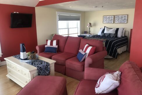 a living room filled with furniture and a flat screen tv.