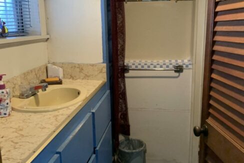 a bathroom with a sink and a window.