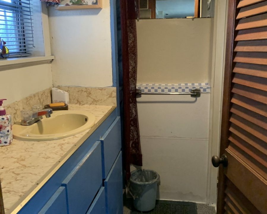 a bathroom with a sink and a window.