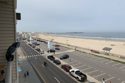 a view of a beach from a balcony of a building.