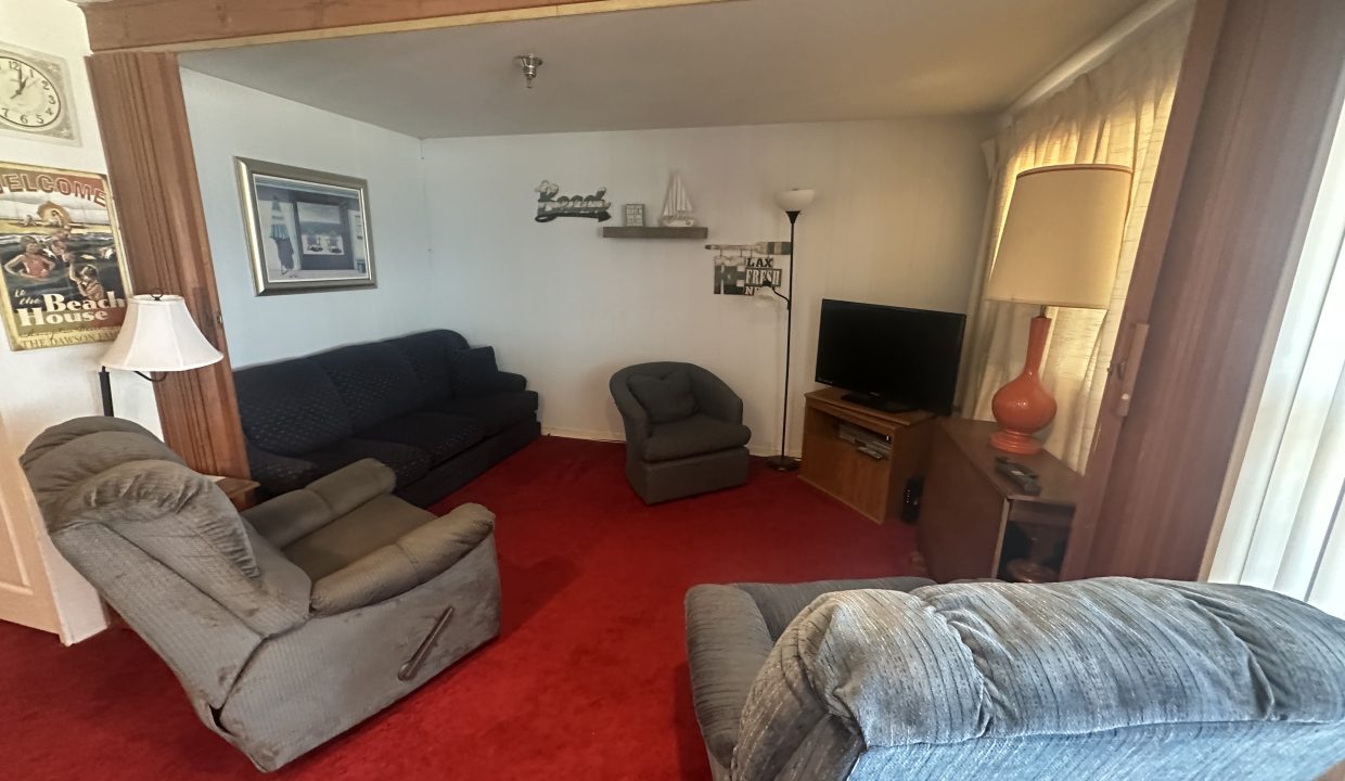 a living room with couches and a tv.