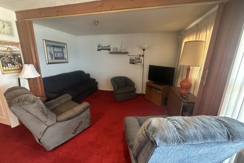 a living room with couches and a tv.