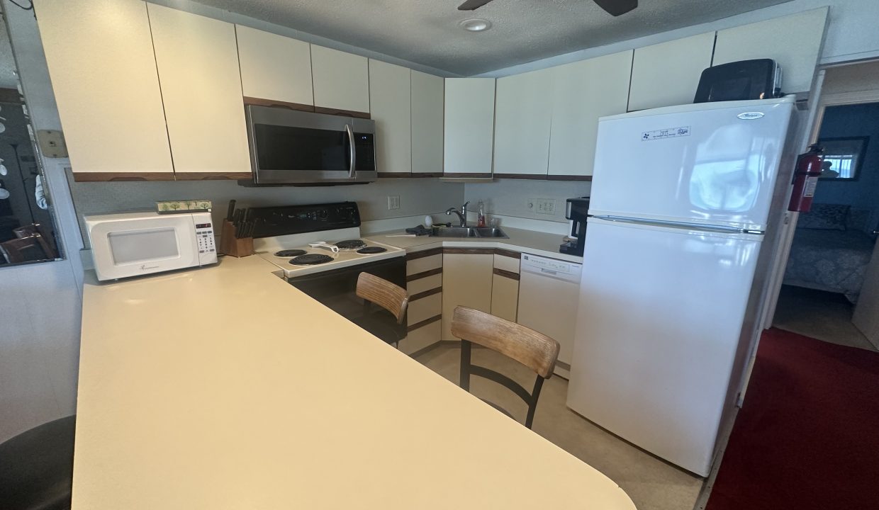 a kitchen with white cabinets and a white counter top.