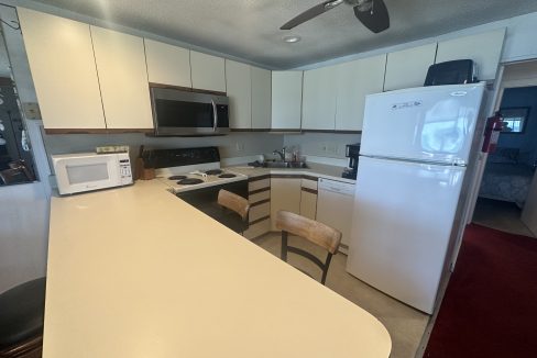 a kitchen with white cabinets and a white counter top.
