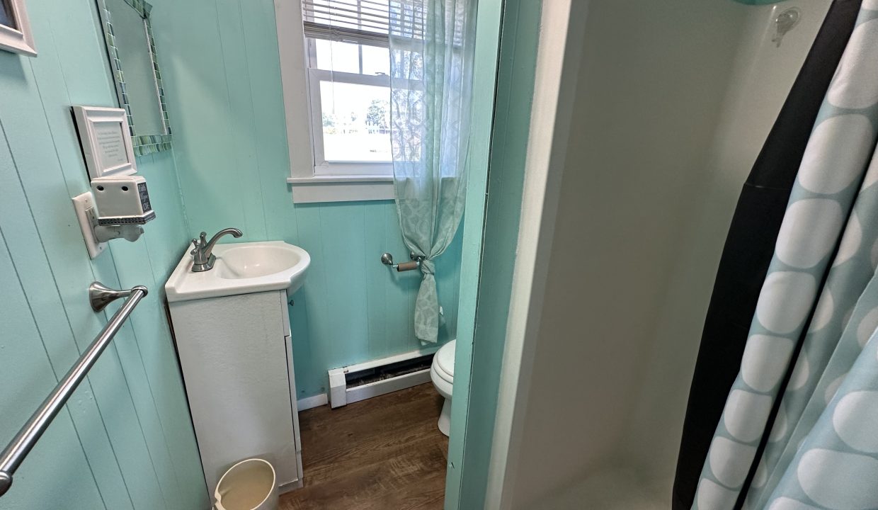 a bathroom with a shower and sink.