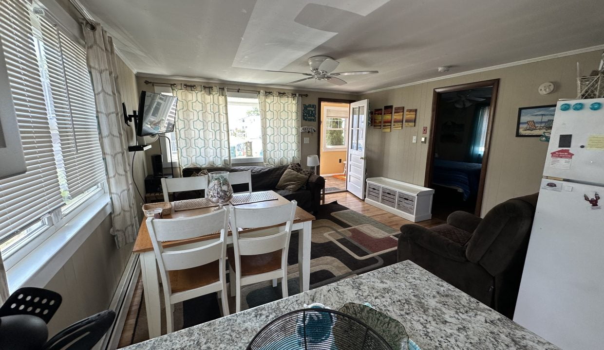 a living room with a table and chairs.