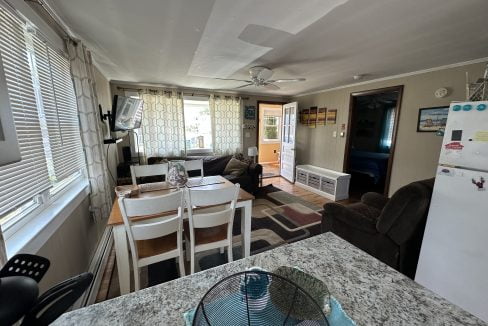 a living room with a table and chairs.