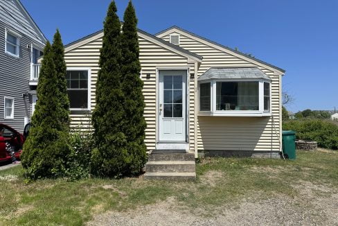 a house with a car parked in front of it.