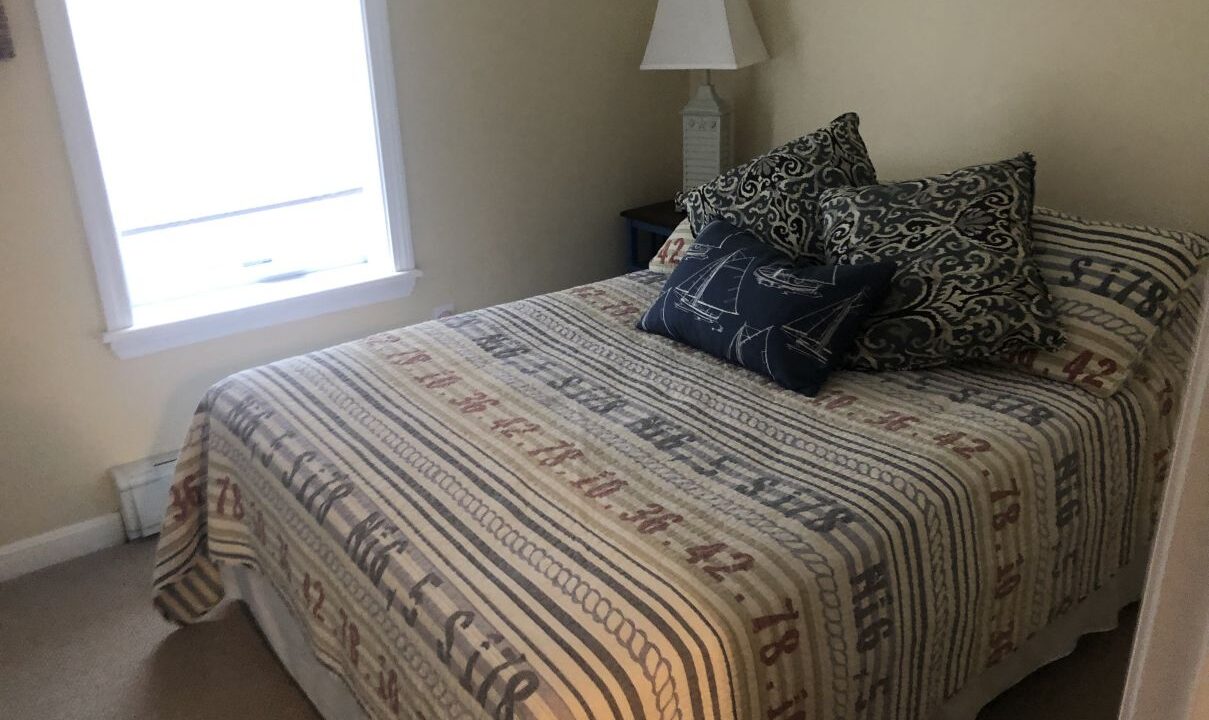 a bedroom with a bed and a window.