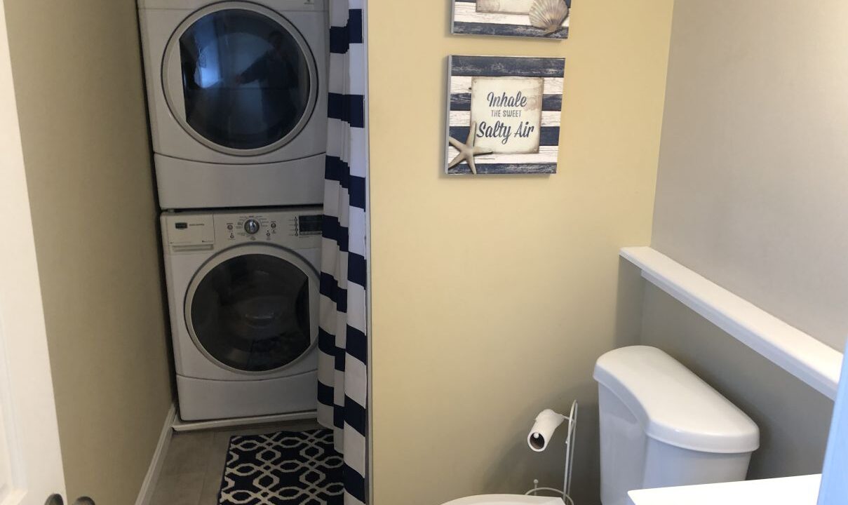 a washer and dryer in a small bathroom.