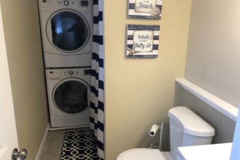 a washer and dryer in a small bathroom.