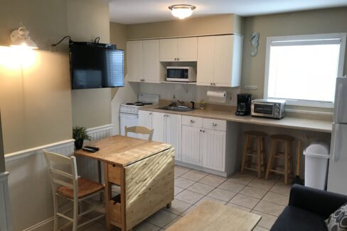 a kitchen with a table and a microwave.