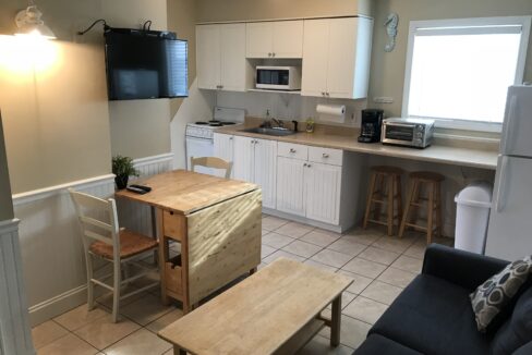 a kitchen and living room with a table and chairs.