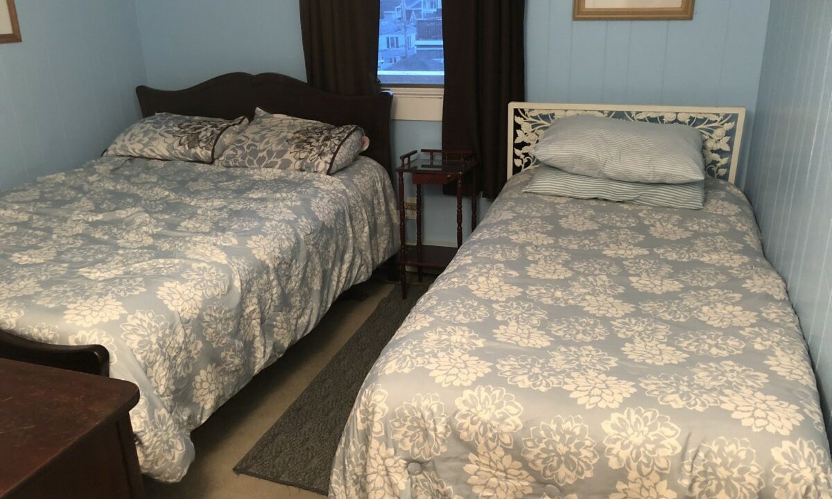a couple of beds sitting next to each other in a bedroom.