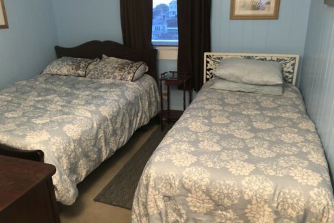 a couple of beds sitting next to each other in a bedroom.