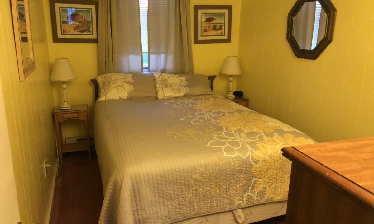 a bed sitting in a bedroom next to a window.