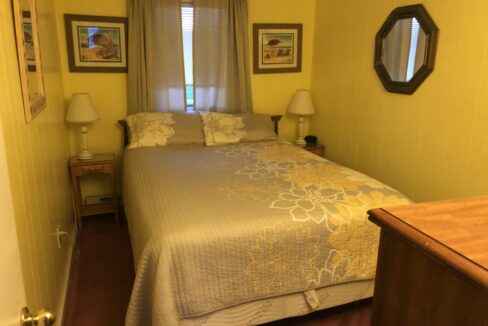 a bed sitting in a bedroom next to a window.