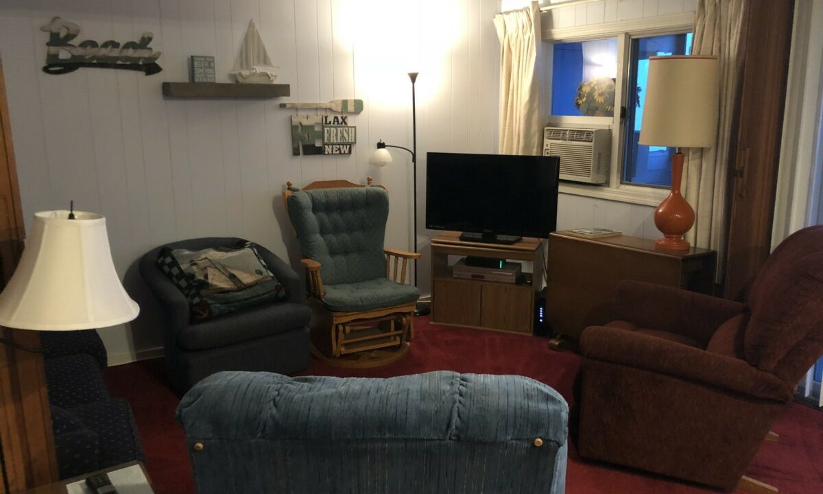 a living room filled with furniture and a flat screen tv.