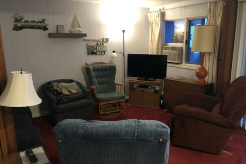 a living room filled with furniture and a flat screen tv.