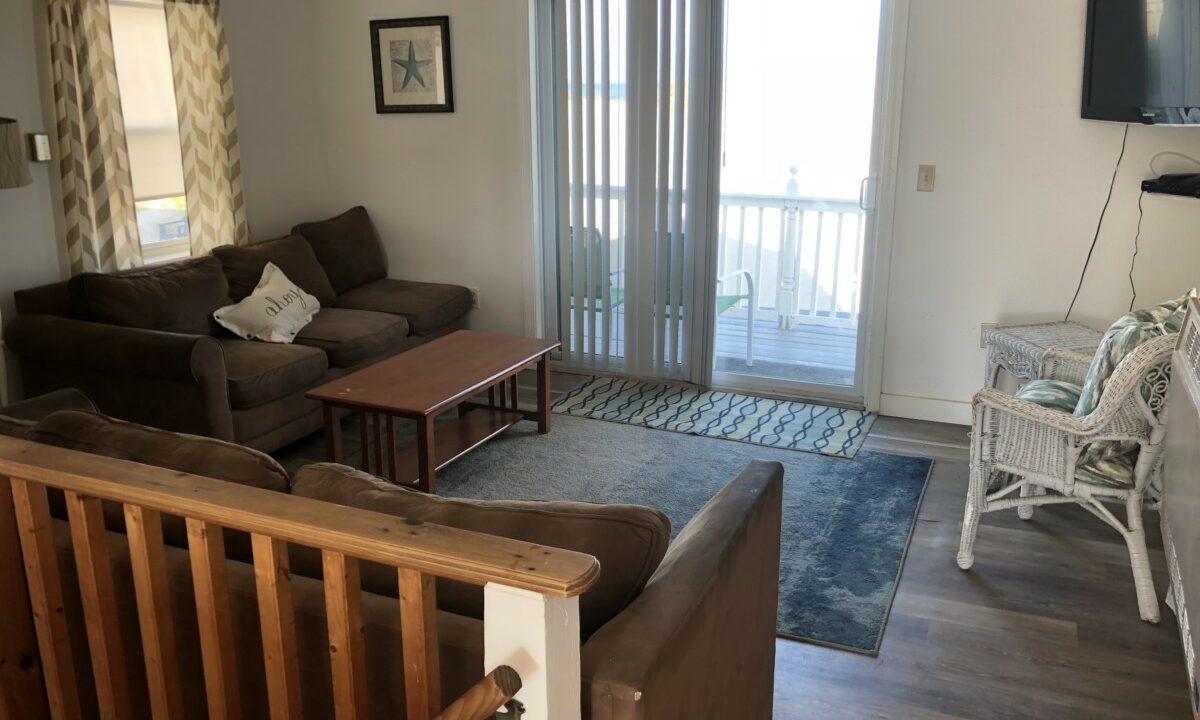 a living room filled with furniture and a flat screen tv.