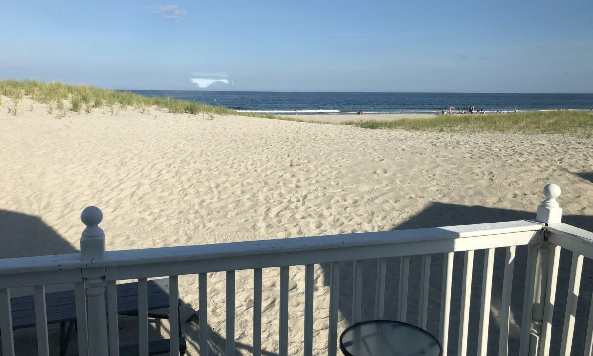 a view of the beach from a deck.