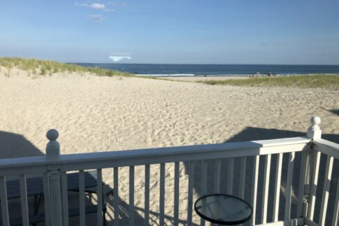 a view of the beach from a deck.