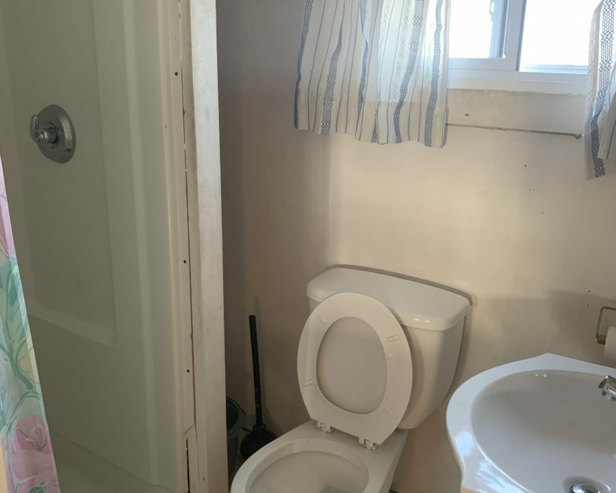 a bathroom with a sink, toilet and shower.
