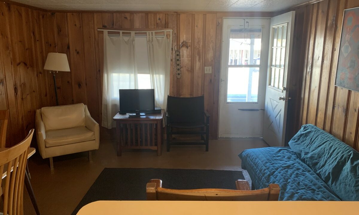 a living room filled with furniture and a flat screen tv.